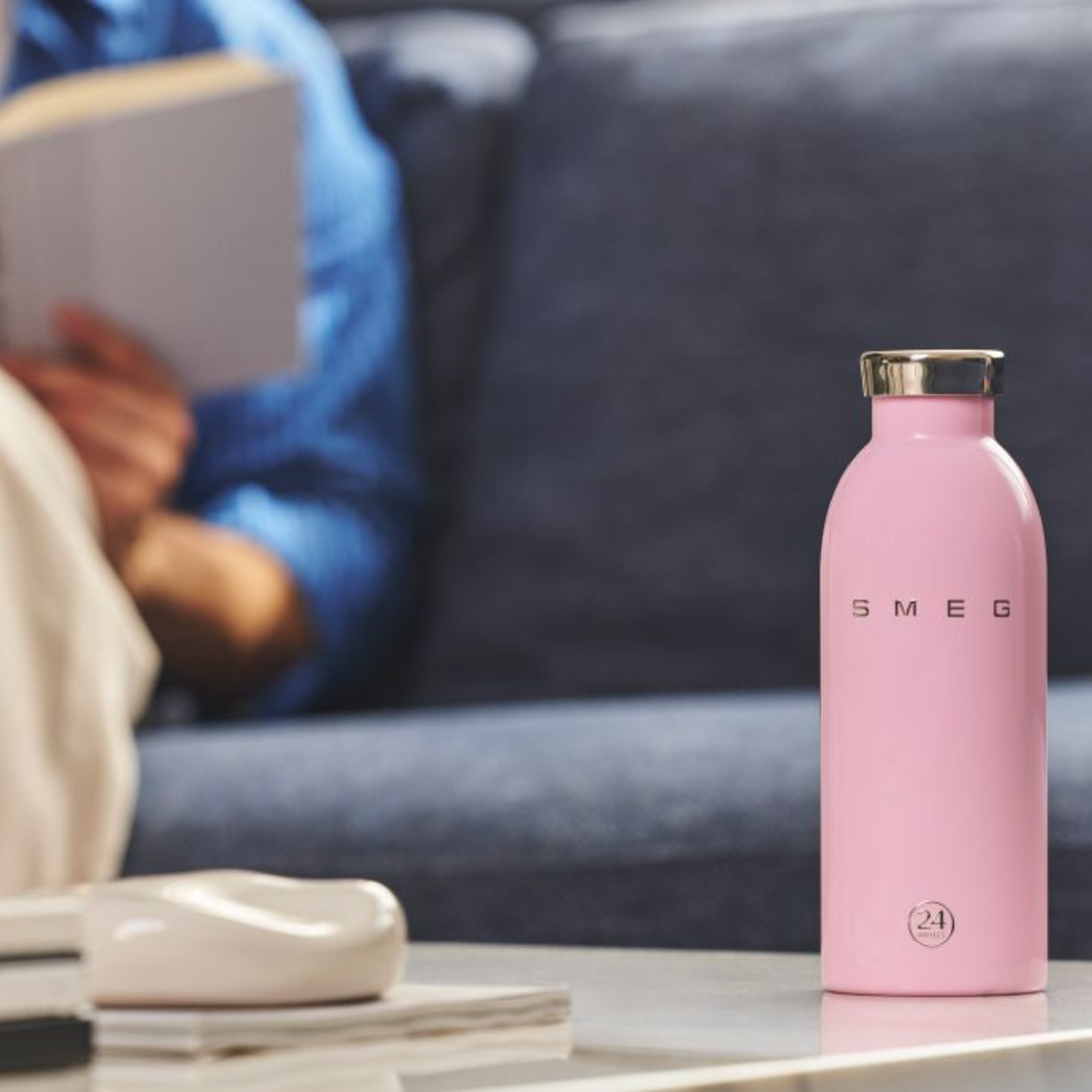 Pink water bottle with silver cap on a white background